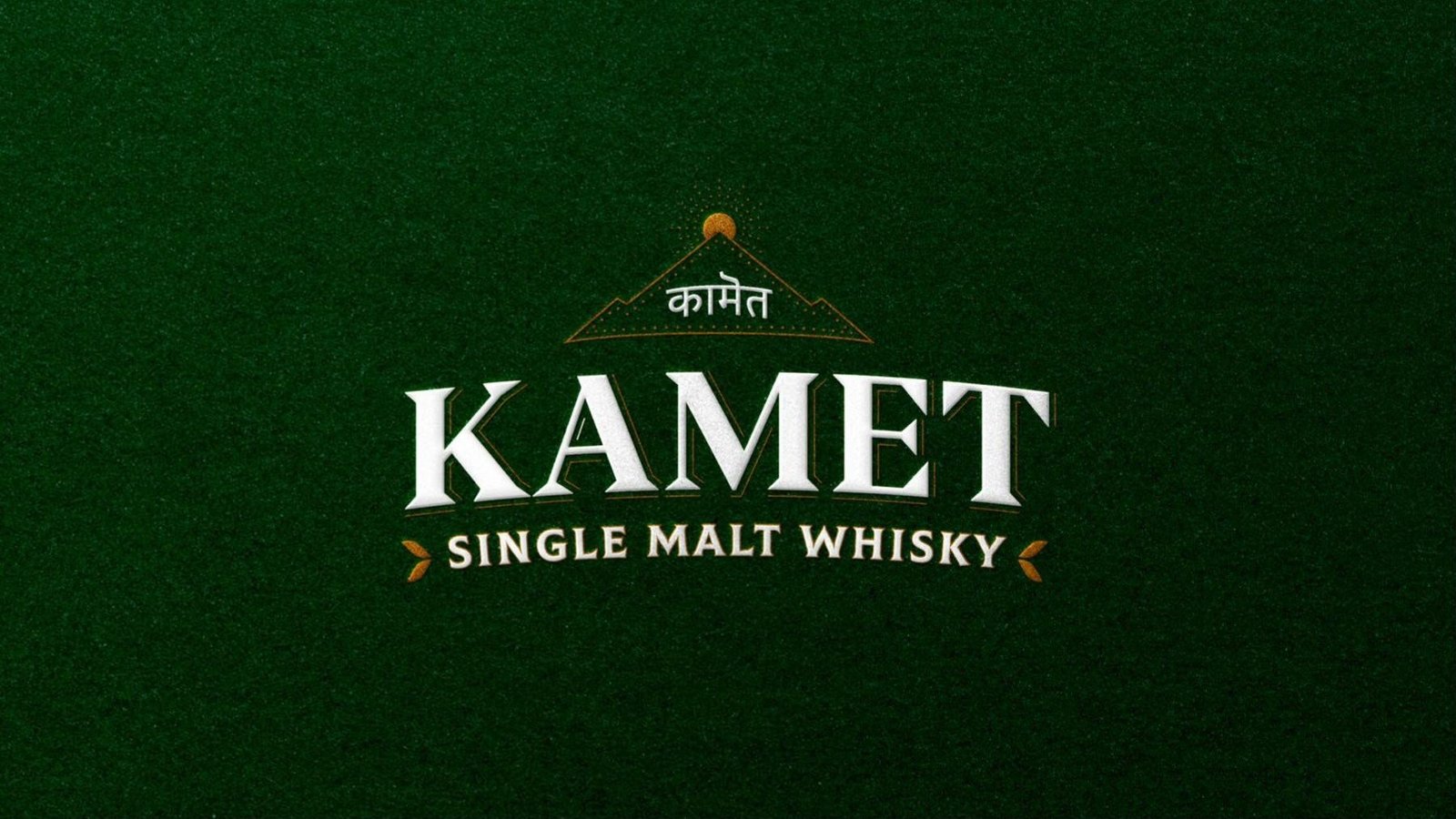 Kamet single malt whisky brand mark on dark green